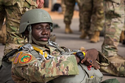 A U.S. Army Soldier assigned to the 19th Special Forces Group (Airborne), Utah Army National Guard, sits on the tarmac of an airport in Grier Labouihi, Morocco, waiting to board a Moroccan C-130 during an airborne operation during African Lion 22, June 19, 2022.