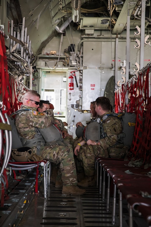 U.S. paratroopers utilizing T-11 parachutes conduct an airborne operation  from a C-130 Hercules aircraft