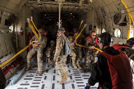 U.S. Army Soldiers assigned to the 19th Special Forces Group (Airborne), Utah Army National Guard, and Royal Moroccan Army paratroopers pull the static lines from their doorways after two sticks of Soldiers successfully jumped out of a C-130 as part of a friendship airborne operation in Grier Labouihi, Morocco, during African Lion 22, June 19, 2022.