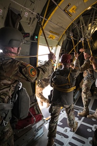 U.S. Army Soldiers assigned to the 19th Special Forces Group (Airborne), Utah Army National Guard, hand off their static lines and exit the plane as part of a friendship airborne operation in Grier Labouihi, Morocco, during African Lion 22, June 19, 2022.