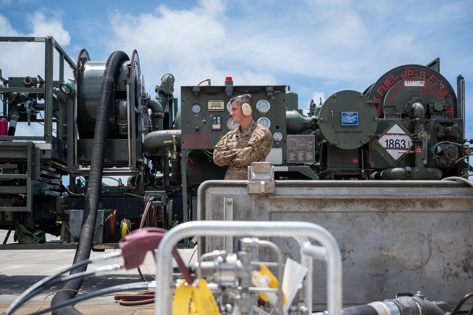 Airman stands in front of a fuel truck