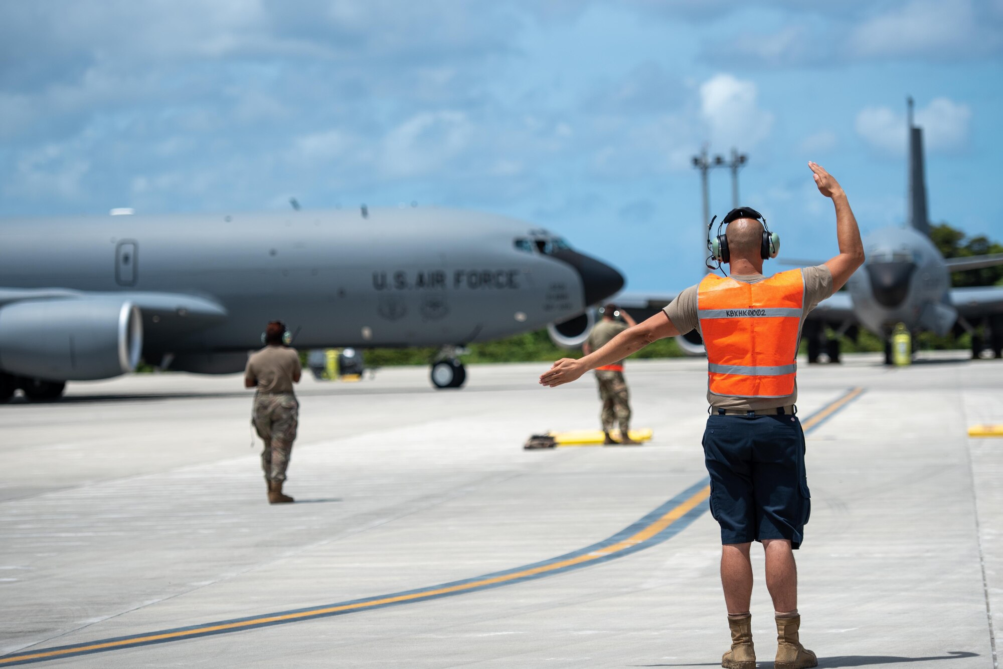 Airman marshals an aircraft onto it's parking spot
