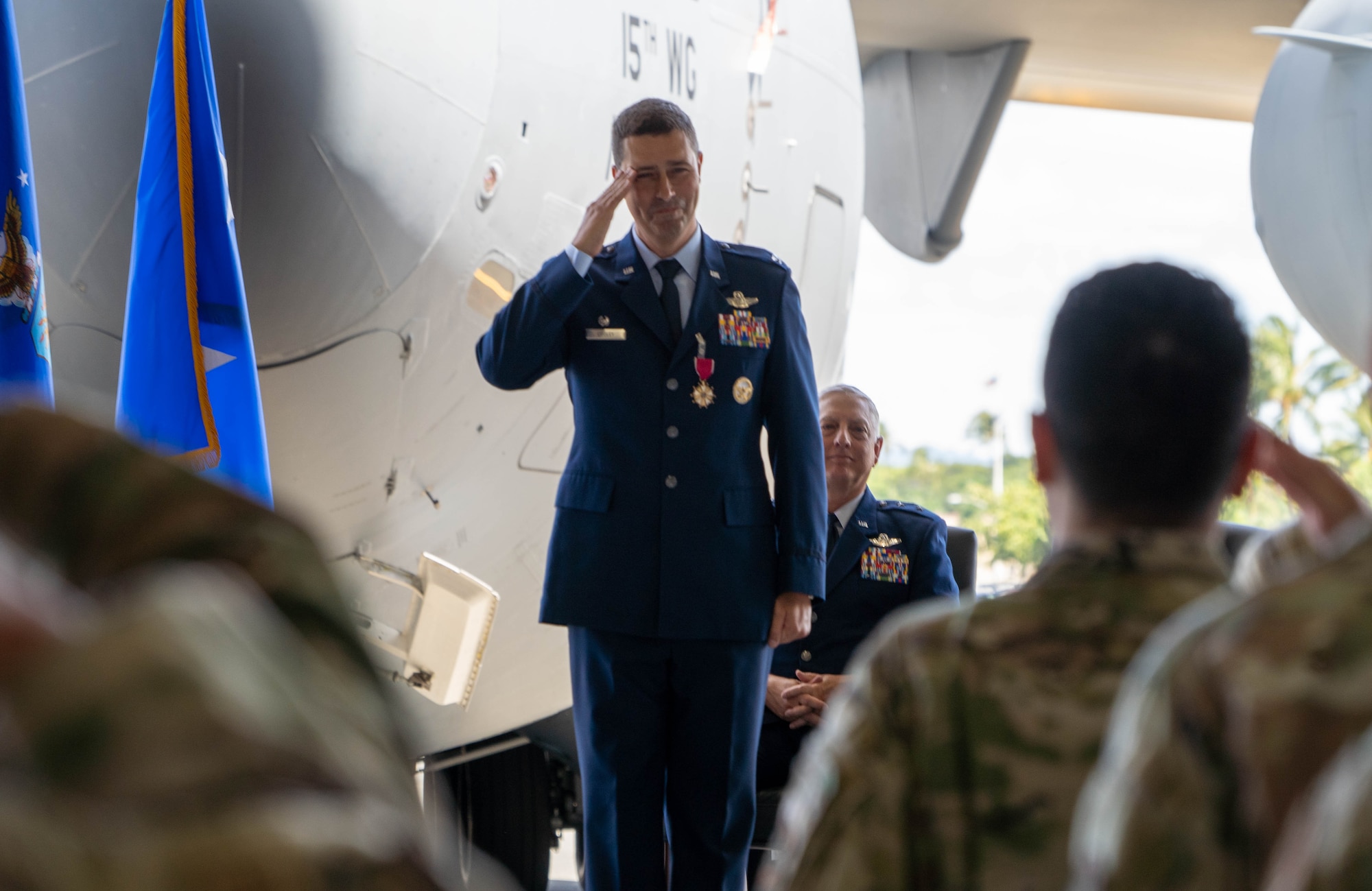 U.S. Air Force Col. Dan Cooley, former 515th Air Mobility Operations Wing commander, offers a final solute to 515th AMOW members during the wing's June 28, 2022 change of command ceremony.
