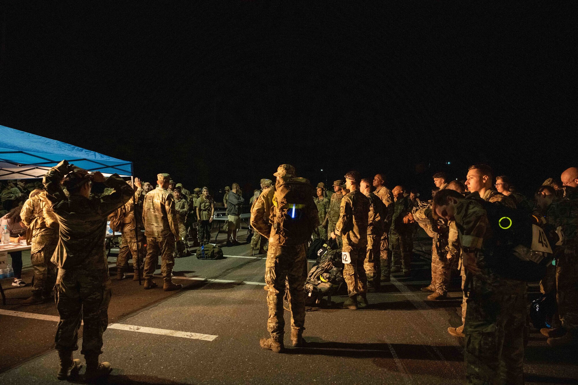 Members of Team Misawa listen to the back story and the importance of the Norwegian Foot March before starting the march at Misawa Air Base, Japan, June 25, 2022.