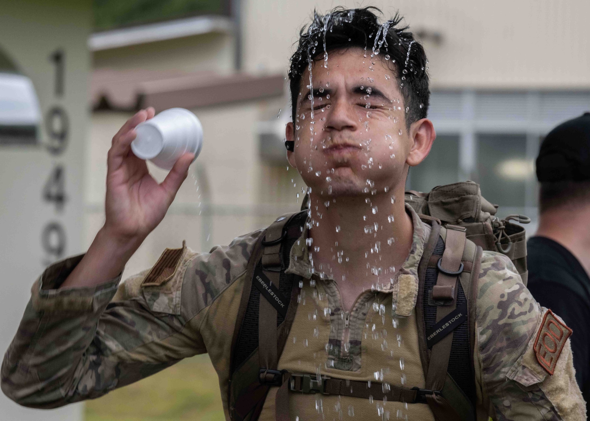 A participant pours water on his head to cool down during a Norwegian Foot March at Misawa Air Base, Japan, June 25, 2022.