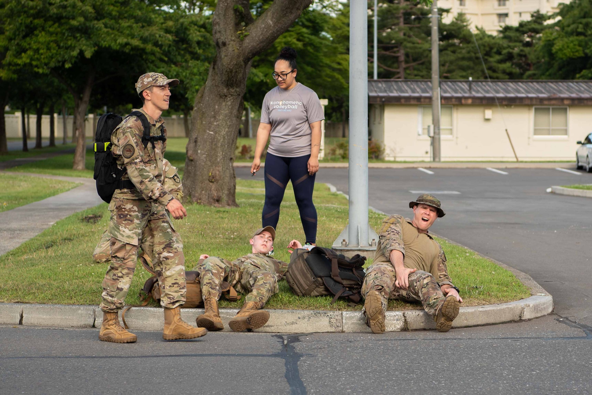 Members of Team Misawa take a break after completing a Norwegian Foot March at Misawa Air Base, Japan, June 25, 2022.