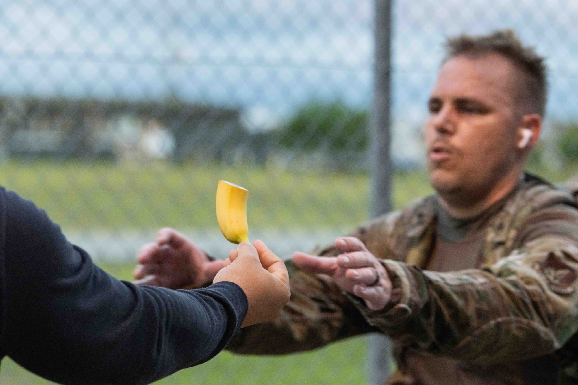 A volunteer hands a banana to a participant during a Norwegian Foot March at Misawa Air Base, Japan, June 25, 2022.