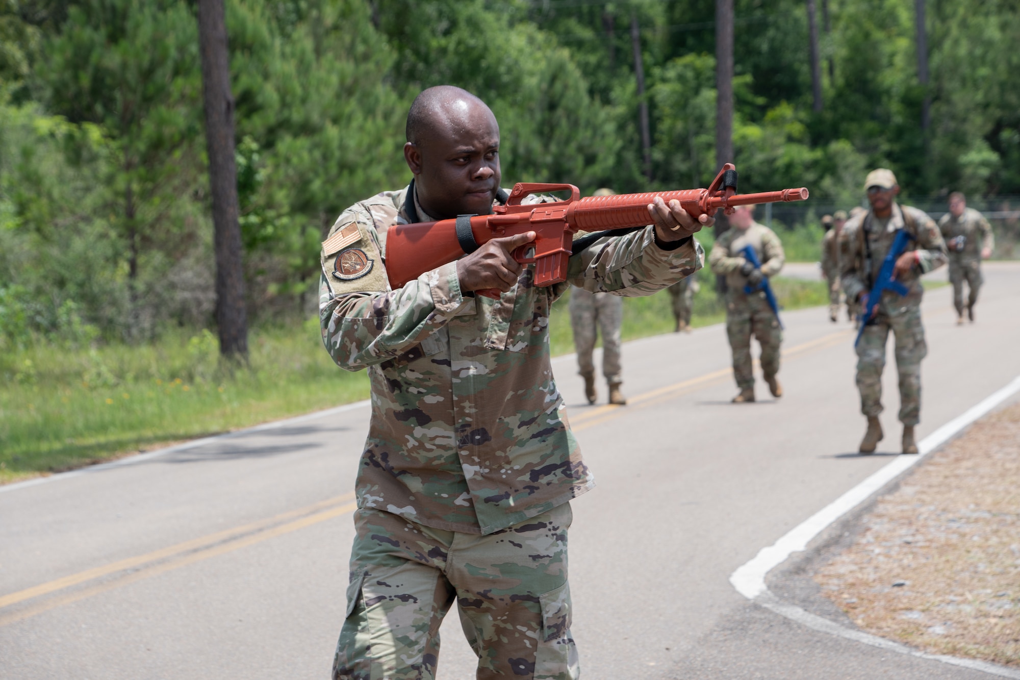 Members from the 221st and 239th Combat Communications Squadrons practice Tactical Combat Casualty Care maneuvers during Exercise BUMBU 22 at Camp Shelby, Miss., June 5, 2022. BUMBU 22 brings five combat communications squadrons with the 254th Combat Communications Group from their home stations located across the nation together for a consolidated training exercise. (Air National Guard photo by Staff Sgt. Adrian Brakeley)