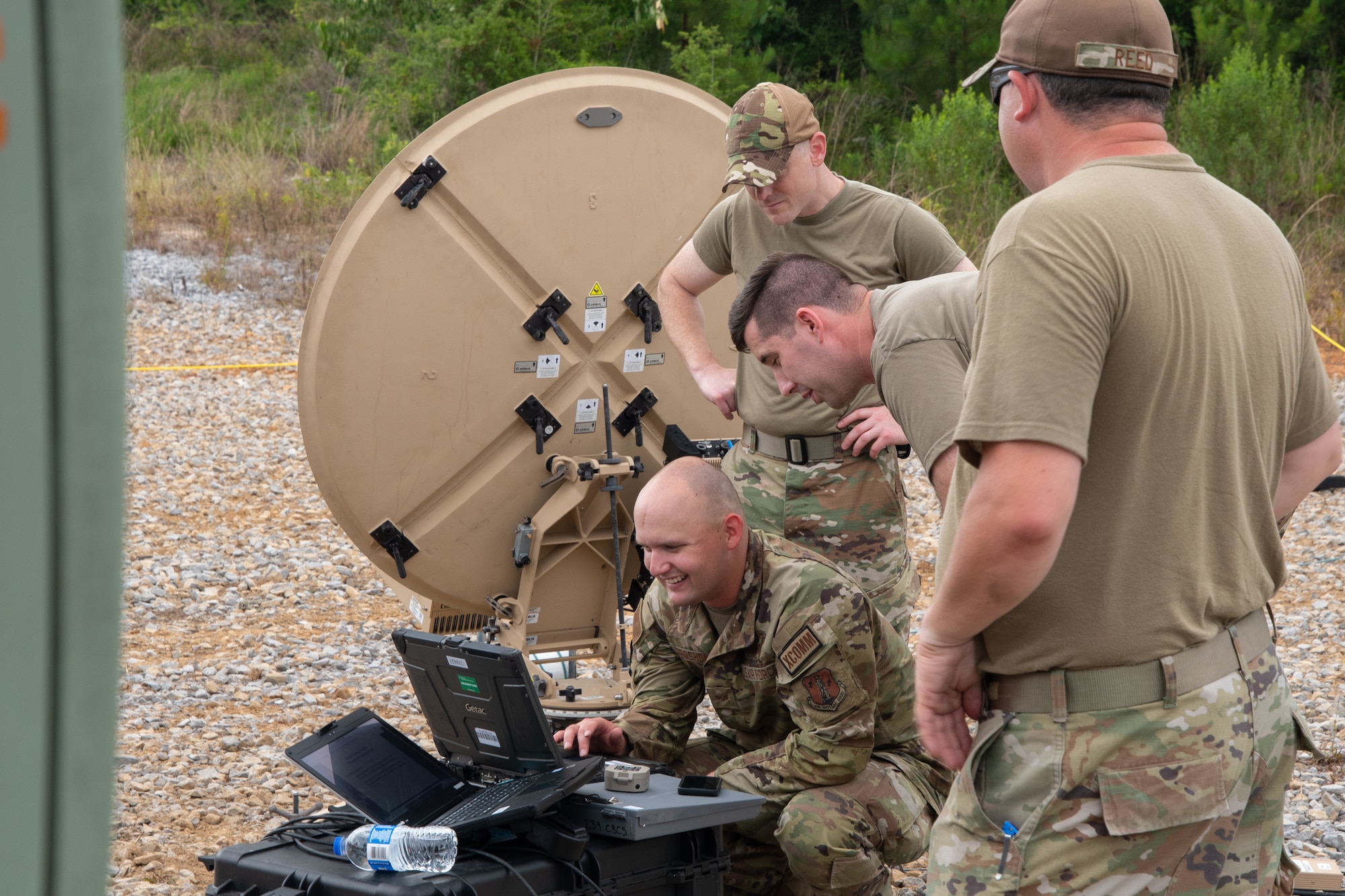 Members of the 239th Combat Communications Squadron ready a satellite communications terminal for use during Exercise BUMBU 22 at Camp Shelby, Miss., June 3, 2022. BUMBU 22 brings five combat communications squadrons with the 254th Combat Communications Group from their home stations located across the nation together for a consolidated training exercise. (U.S. Air National Guard photo by Staff Sgt. Adrian Brakeley)