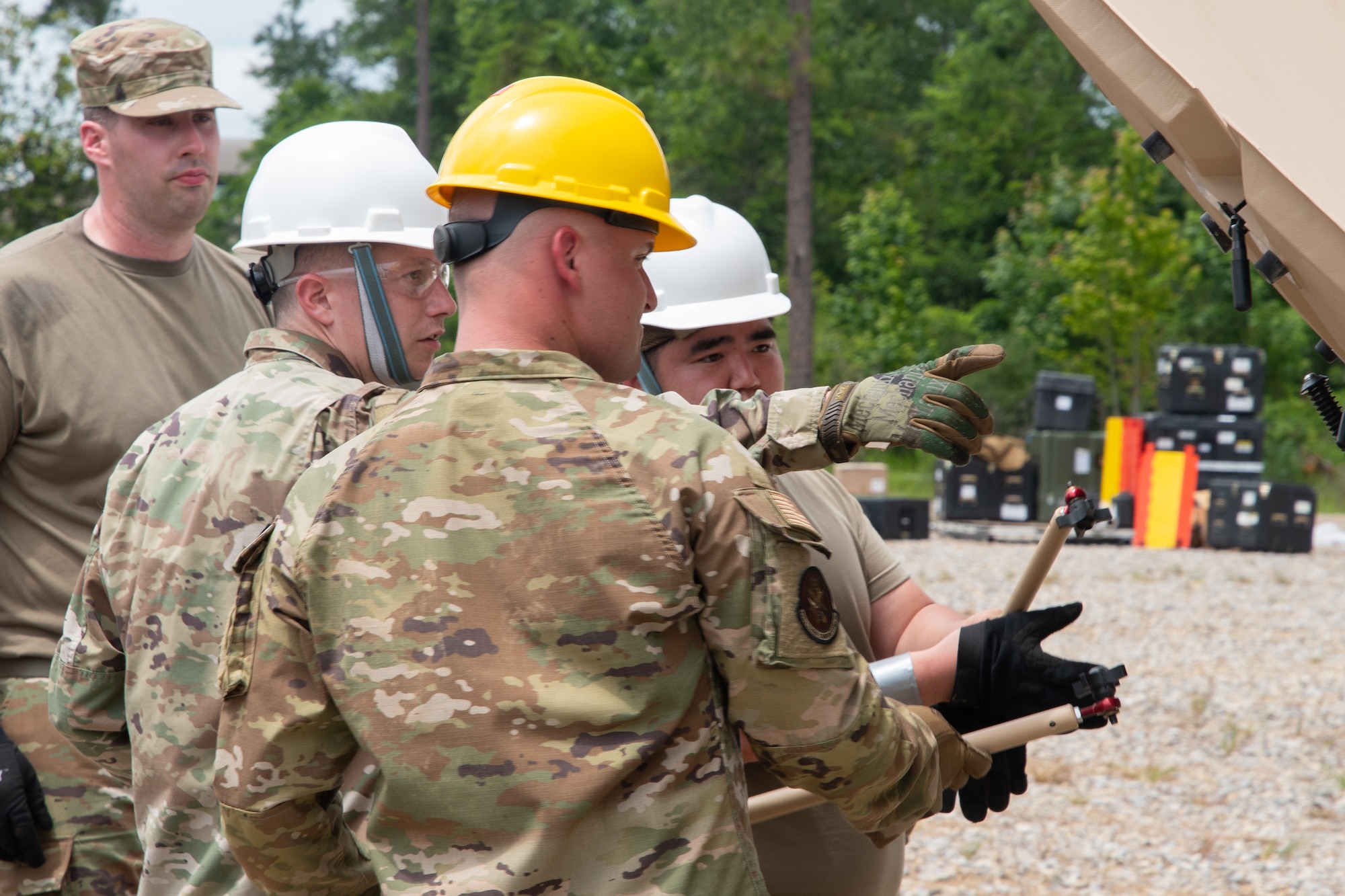 Members of the 239th Combat Communications Squadron ready a satellite communications antenna for use during Exercise BUMBU 22 at Camp Shelby, Miss., June 3, 2022. BUMBU 22 brings five combat communications squadrons with the 254th Combat Communications Group from their home stations located across the nation together for a consolidated training exercise. (U.S. Air National Guard photo by Staff Sgt. Adrian Brakeley)