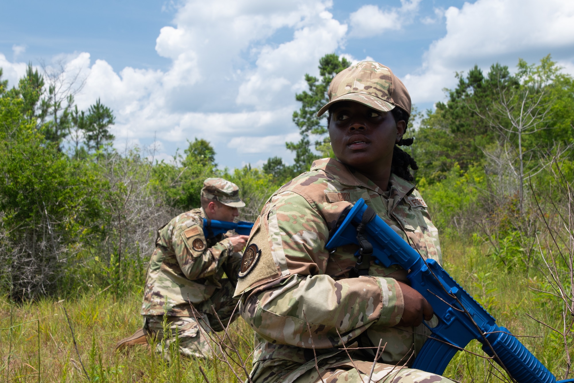 Members from the 221st and 239th Combat Communications Squadrons practice suppressive fire techniques as part of Tactical Combat Casualty Care maneuvers during Exercise BUMBU 22 at Camp Shelby, Miss., June 5, 2022. BUMBU 22 brings five combat communications squadrons with the 254th Combat Communications Group from their home stations located across the nation together for a consolidated training exercise. (Air National Guard photo by Staff Sgt. Adrian Brakeley)