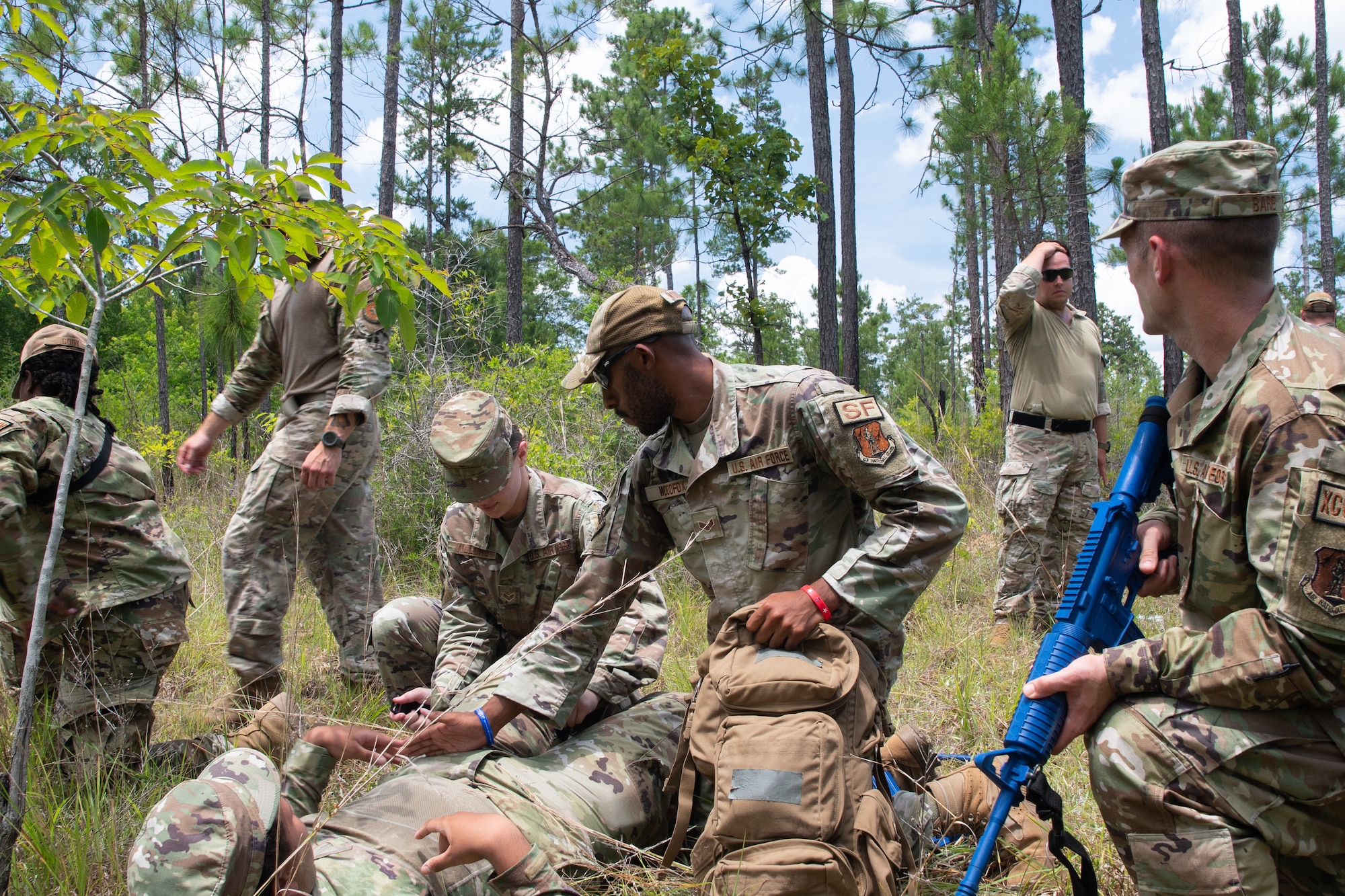 Members from the 221st and 239th Combat Communications Squadrons practice Tactical Combat Casualty Care maneuvers during Exercise BUMBU 22 at Camp Shelby, Miss., June 5, 2022. BUMBU 22 brings five combat communications squadrons with the 254th Combat Communications Group from their home stations located across the nation together for a consolidated training exercise. (Air National Guard photo by Staff Sgt. Adrian Brakeley)