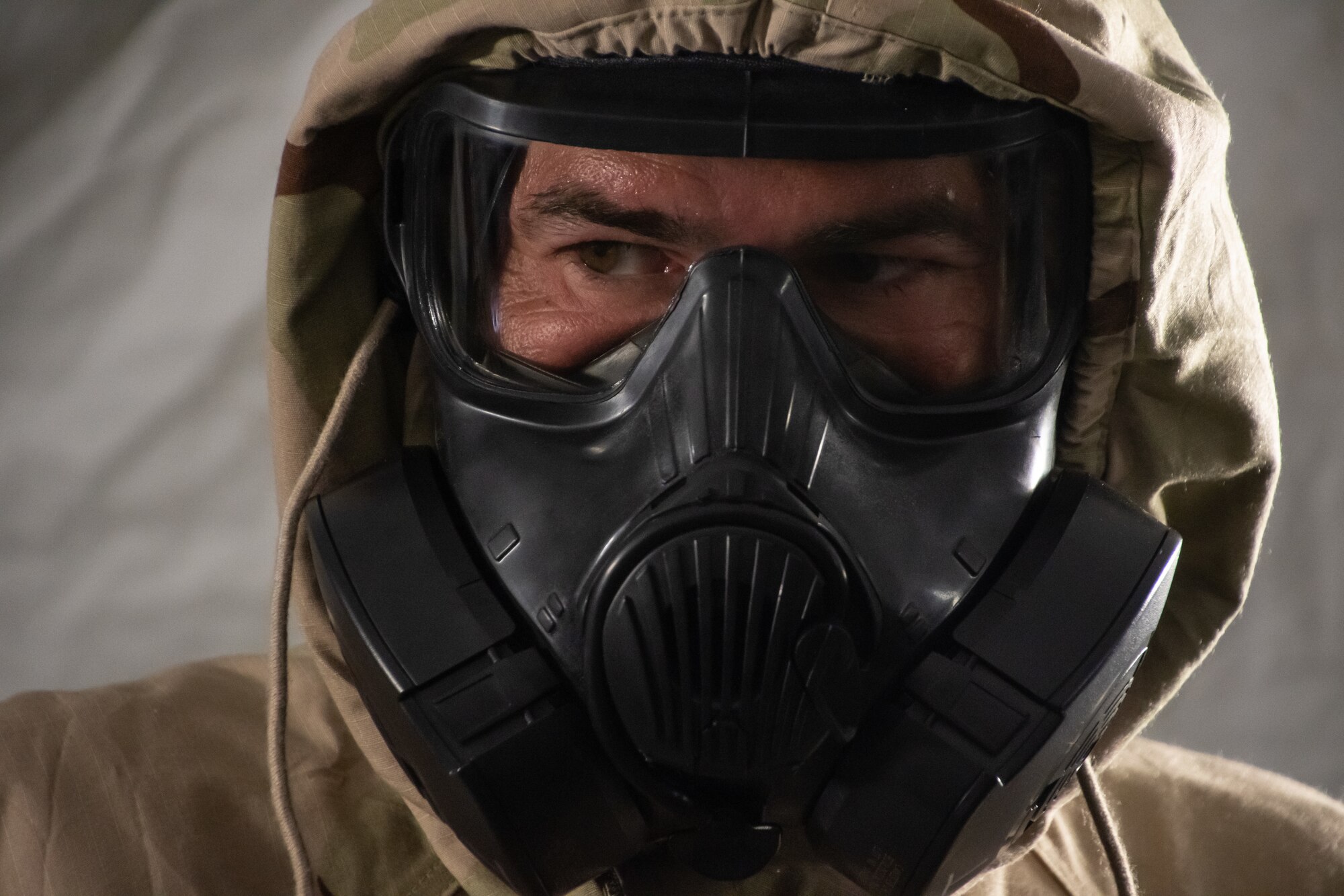 Members of the 239th Combat Communications Squadron practice putting on protective gear during a chemical agents and warfare drill during Exercise BUMBU 22 at Camp Shelby, Miss., June 4, 2022. BUMBU 22 brings five combat communications squadrons with the 254th Combat Communications Group from their home stations located across the nation together for a consolidated training exercise. (U.S. Air National Guard photo by Airman 1st Class Kelly Ferguson)