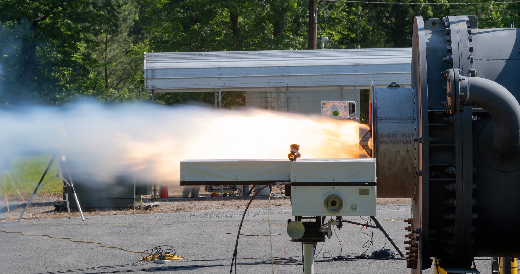 Flame and smoke shoot out of a towed airborne plume simulator