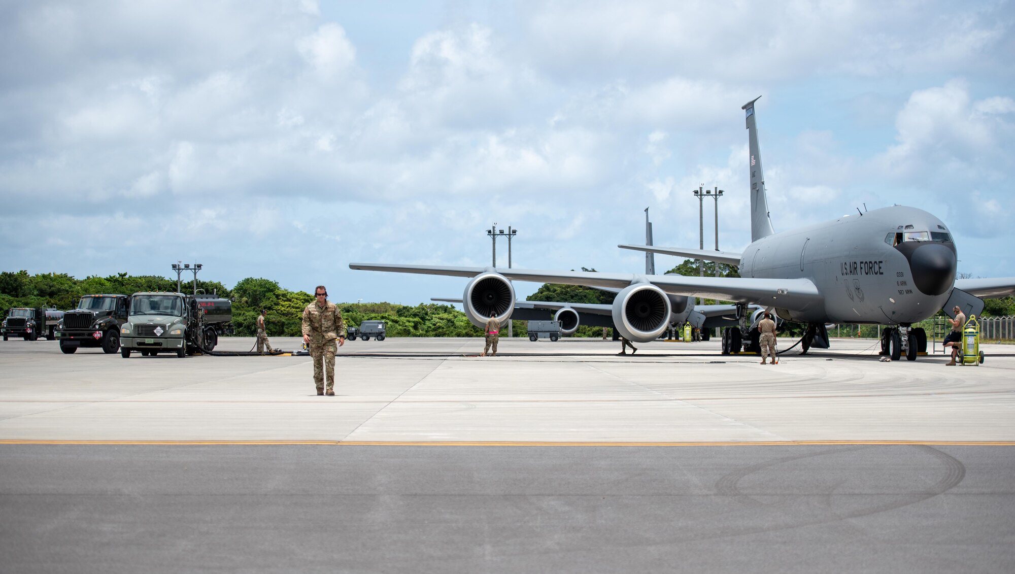 Airman performing hot-pit refueling on an aircraft