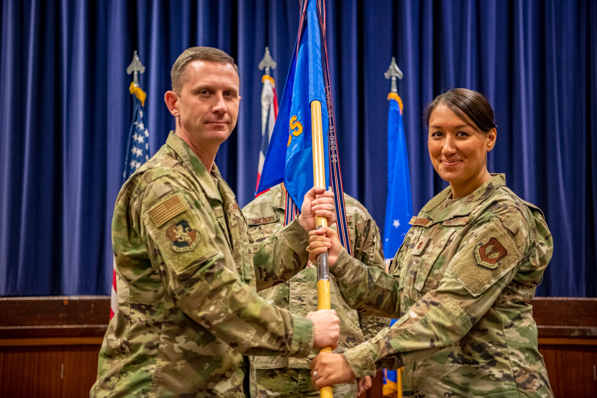 U.S. Air Force Maj. Amanda Altman, right, 422d Communications Squadron incoming commander, receives the guidon from Col. Jon T. Hannah, 422d Air Base Group commander, during an assumption of command ceremony at RAF Croughton, England, June 27, 2022.  Altman completed an Air University Fellowship at Maxwell Air Force Base, Alabama, prior to assuming command of the 422d CS. (U.S. Air Force photo by Staff Sgt. Eugene Oliver)