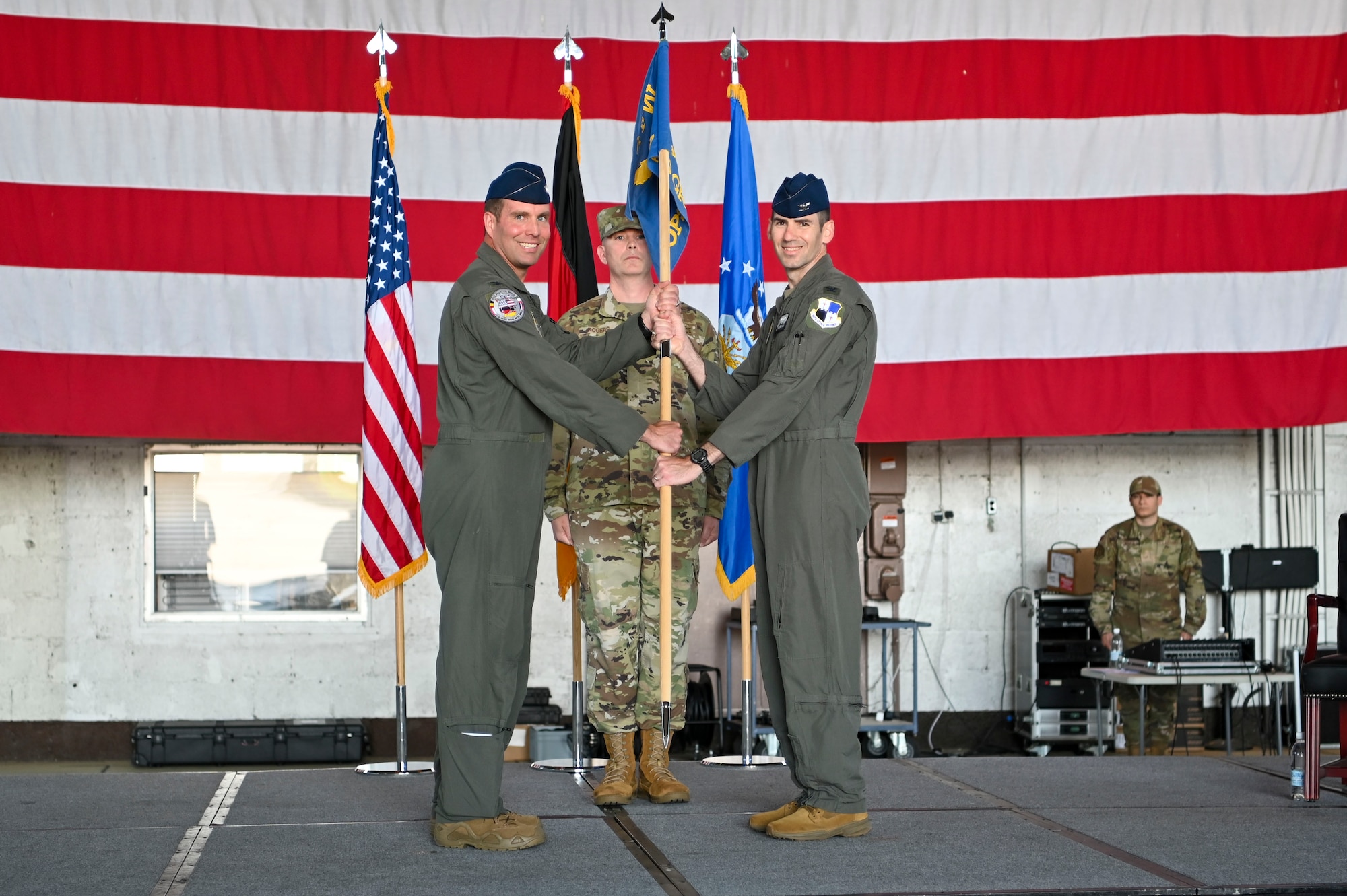 Col. Thomas Graham, right, assumes command of the 52nd Operations Group from Col. Leslie Hauck, 52nd Fighter Wing commander, during an assumption of command ceremony, June 28, 2022, on Spangdahlem Air Base, Germany. The ceremonial passing of the guidon is the single event which most embodies the institution and responsibility of the position of command. (U.S. Air Force photo by Senior Airman Jessica Sanchez-Chen)