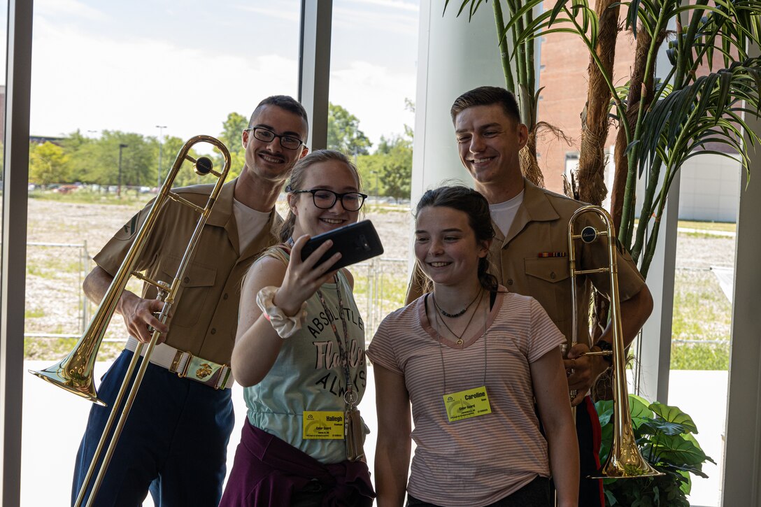 Marine Corps Force Reserve Band Trombonists U.S. Marines Lance Cpl. Grant G. Gallatin (left) and Cpl. Jacob D. Everett takes a break for with campers during a performance at the Music for All (MFA) Summer Symposium 2022 at Ball State University in Muncie, Ind., June 28, 2022. Marine musicians have the opportunity to share their love of music with attending students and increase awareness of the Marine Corps’ opportunities through partnerships with organizations like MFA. Each partnership is developed with the intention of connecting Marines with organizations in order to build relationships and understanding of the Marine Corps. (U.S. Marine Corps photo by Lance Cpl. Gustavo Romero)