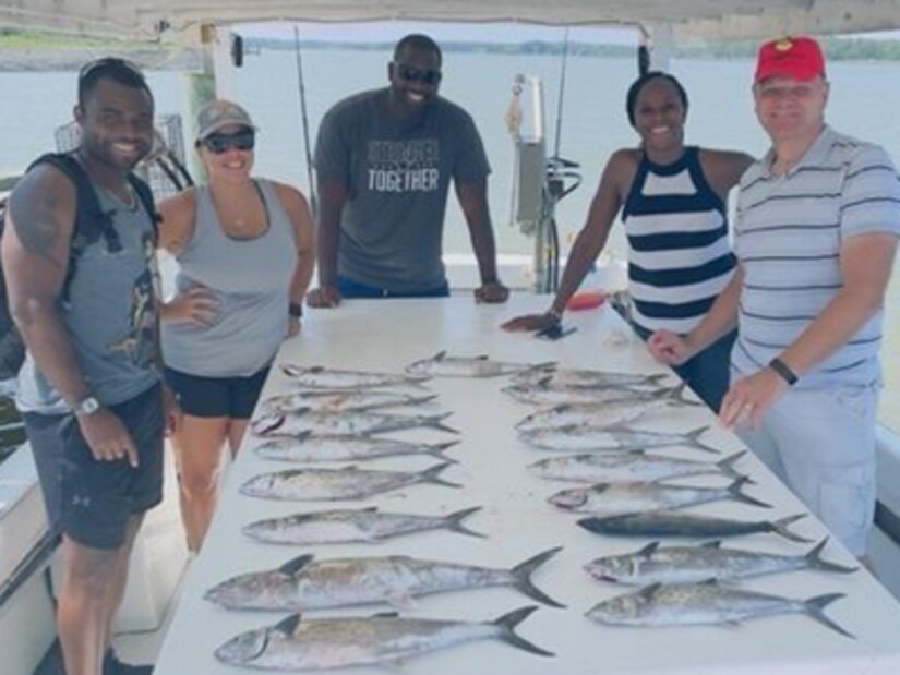 Staff Sgt. Roy Thompson and fellow Soldiers add to the bounty of fish caught on a trip from the Walter Reed Soldier Recovery unit at Taylors Island Delaware in 2021