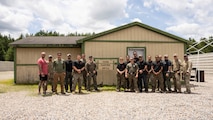 U.S. Marines with Training Company, Marine Corps Security Forces Regiment (MCSFR), Fleet Marine Force, Atlantic, Marine Forces Command, Marine Forces Northern Command and personnel with Chesapeake Special Weapons And Tactics Team, Federal Bureau of Investigation, Pentagon Force Protection Agency, U.S. Department of Energy, conclude integration training with a group photo at Naval Support Activity Northwest Annex, Chesapeake, Virginia, June 21, 2022. Personnel from various organizations gathered to compare marksmanship and close-quarters battle tactics with the U.S. Marines. MCSFR organizes, trains, and equips anti-terrorism security forces in order to conduct expeditionary security operations and provide security for vital national assets. (U.S. Marine Corps photo by Cpl. Hannah Adams)