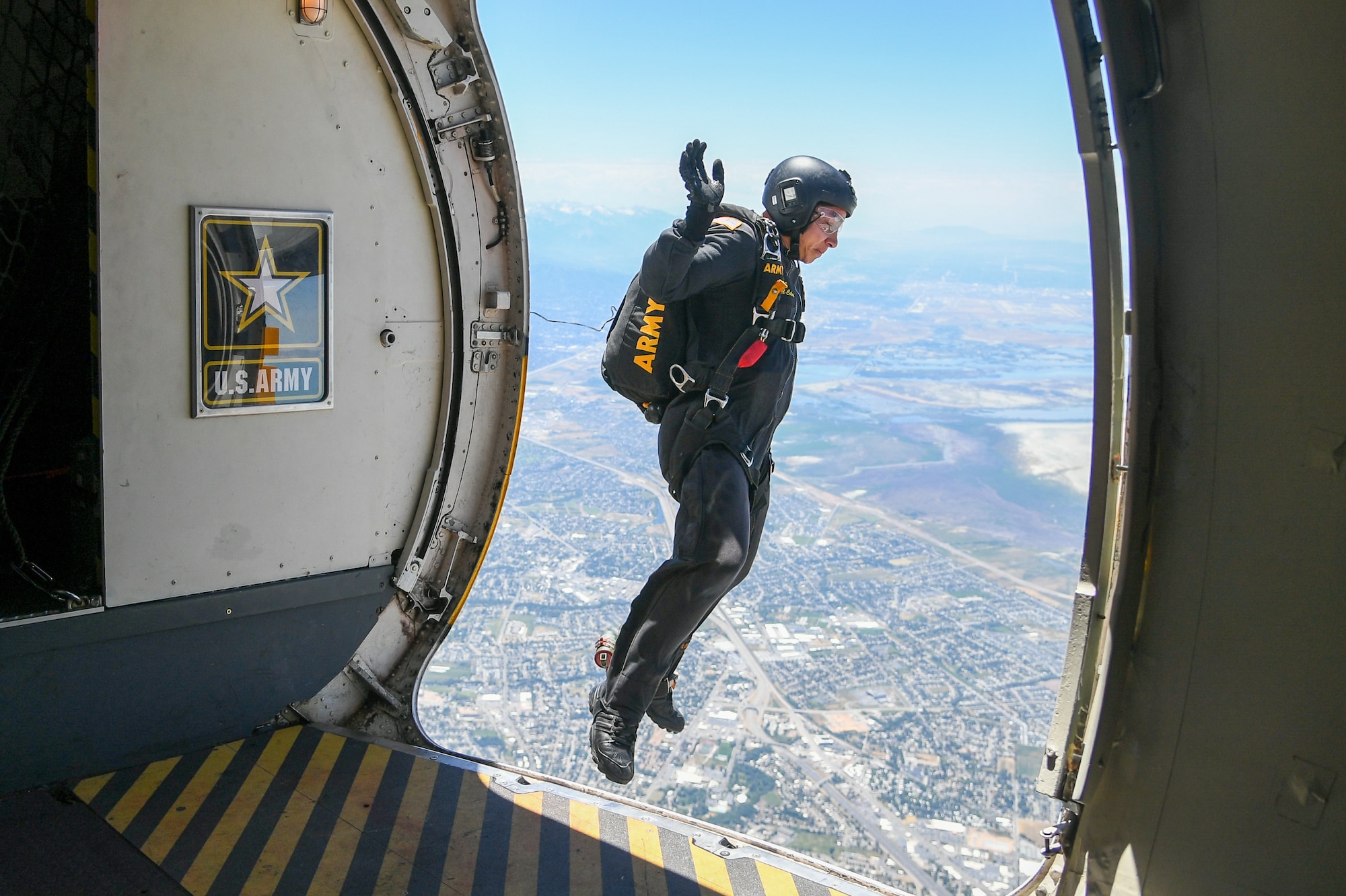A Golden Knights team member pictured mid-air outside the aircraft's door.
