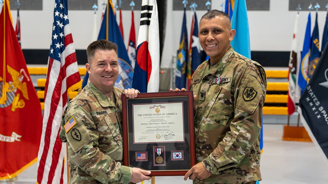 DLA Indo-Pacific Military Deputy Commander Army Col. Brian Donahue and Army Lt. Col. Jose Medina hold a plaque