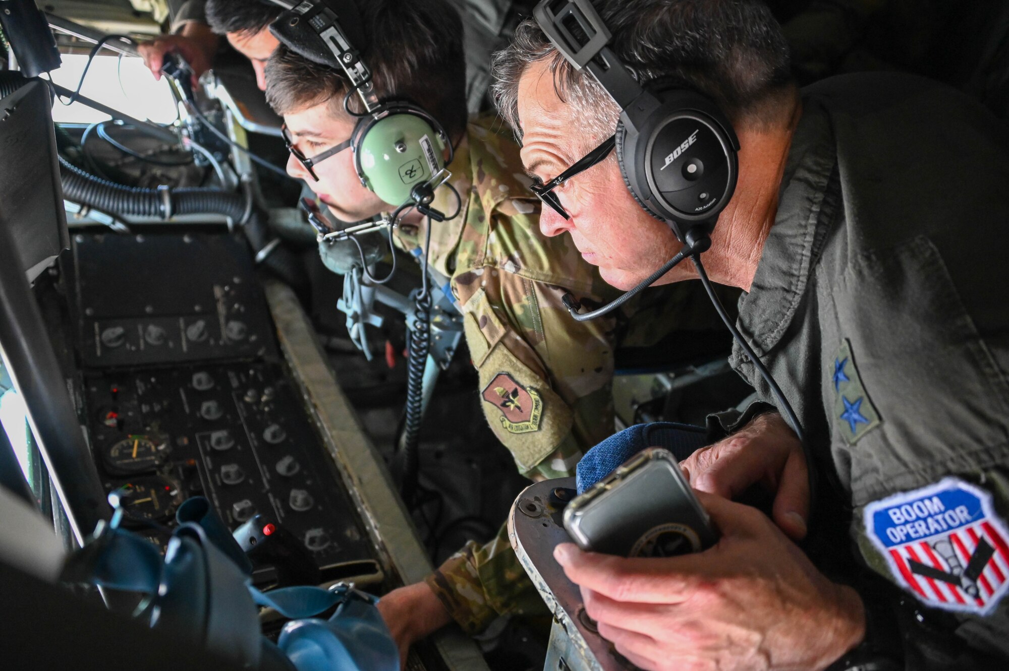 U.S. Air Force Maj. Gen. Craig D. Wills, 19th Air Force commander, takes a photo with 97th Maintenance Group members at Altus Air Force Base, Oklahoma, June 23, 2022. Wills visited the tire shop to learn about a new way of making KC-46 Pegasus tires. (U.S. Air Force photo by Senior Airman Kayla Christenson)