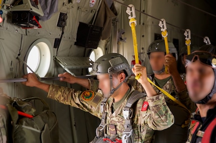 Tunisian paratroopers prepare to hand off their static lines and exit the plane as part of a friendship airborne operation in Grier Labouihi, Morocco, during African Lion 22,  June 19, 2022.