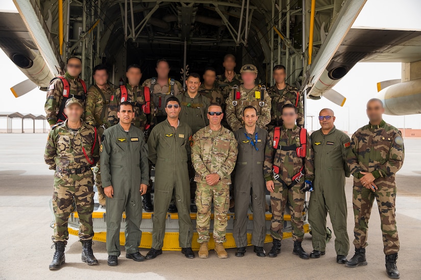 U.S. Army Maj. Gen. Andrew M. Rohling, commander of Southern European Task Force, Africa, accompanied by Soldiers assigned to the 19th Special Forces Group (Airborne), Utah Army National Guard, and Royal Moroccan Army soldiers stand at the back of a Moroccan C-130 for a group photo during the friendship airborne operation in Grier Labouihi, Morocco, as part of African Lion 22, June 19, 2022.