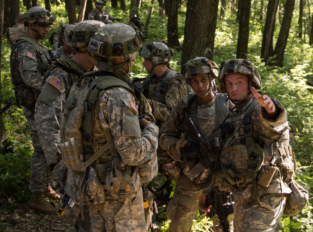 An infantry squad leader with the 2nd Battalion, 130th Infantry Regiment, 33rd Infantry Brigade Combat Team directs his men to a different position during a platoon attack training exercise during eXportable Combat Training Capability 17.2 at Fort McCoy, Wisconsin, June 7, 2017.
