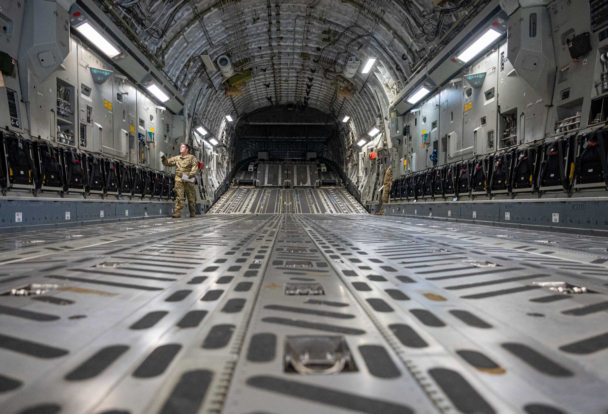 Staff Sgt. Daniel Lawrence, 3rd Airlift Squadron loadmaster, performs preflight checks in the cargo compartment of a C-17 Globemaster III before a local training mission at Dover Air Force Base, Delaware, June 15, 2022. The 3rd AS trains regularly to provide global reach with unique, outsized airlift capability. (U.S. Air Force photo by Senior Airman Faith Schaefer)