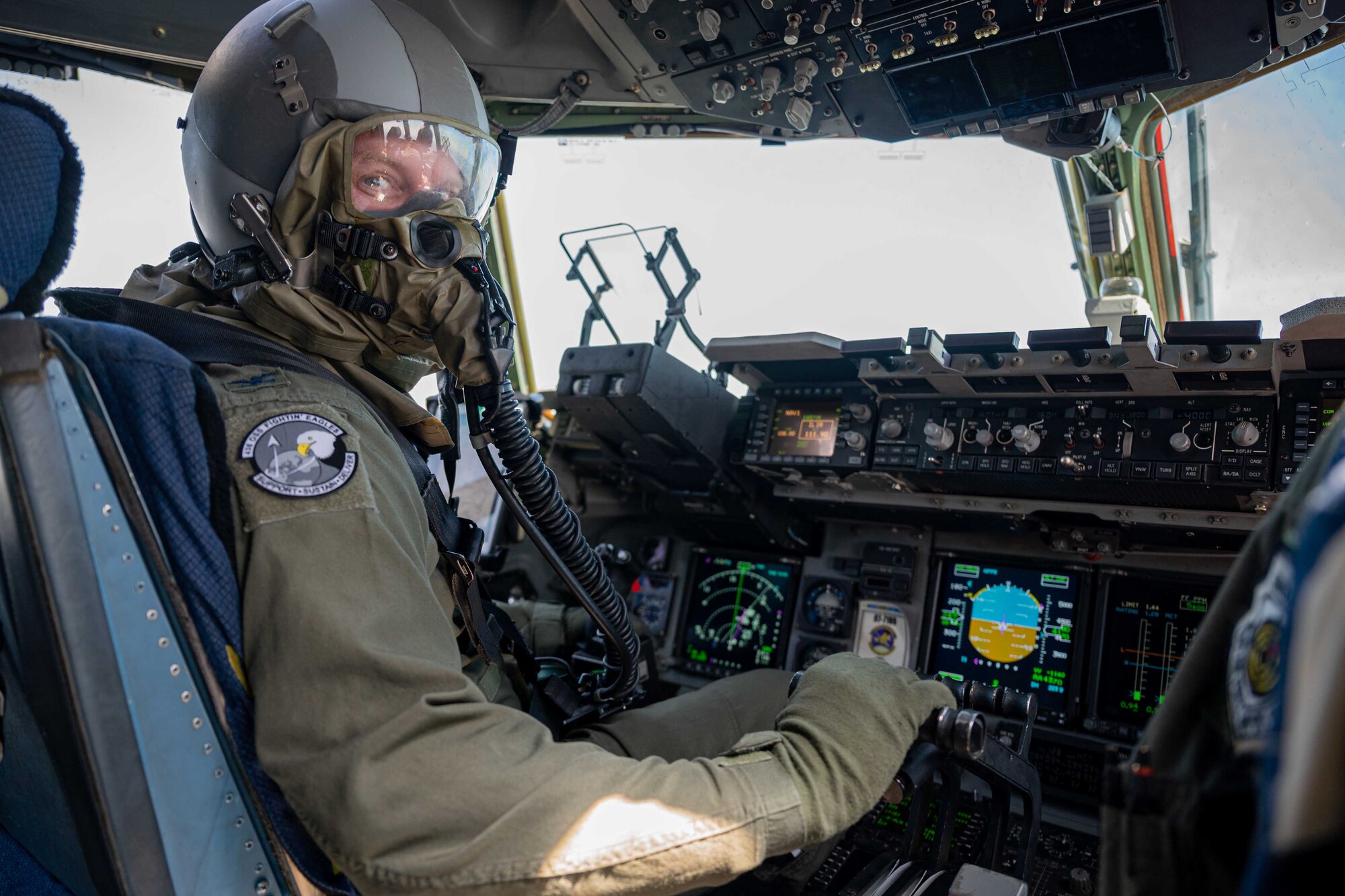 Col. Scott Raleigh, 436th Operations Group commander, flies a C-17 Globemaster III while wearing aircrew eye and respiratory protection system equipment during a local training mission at Dover Air Force Base, Delaware, June 15, 2022. Training with AERPS allows for scenario-based preparation for possible real-world situations involving chemical, biological, radiological and nuclear environments. The local training flight included members from the 436th OG, 3rd Airlift Squadron and 436th Operations Support Squadron. (U.S. Air Force photo by Senior Airman Faith Schaefer)