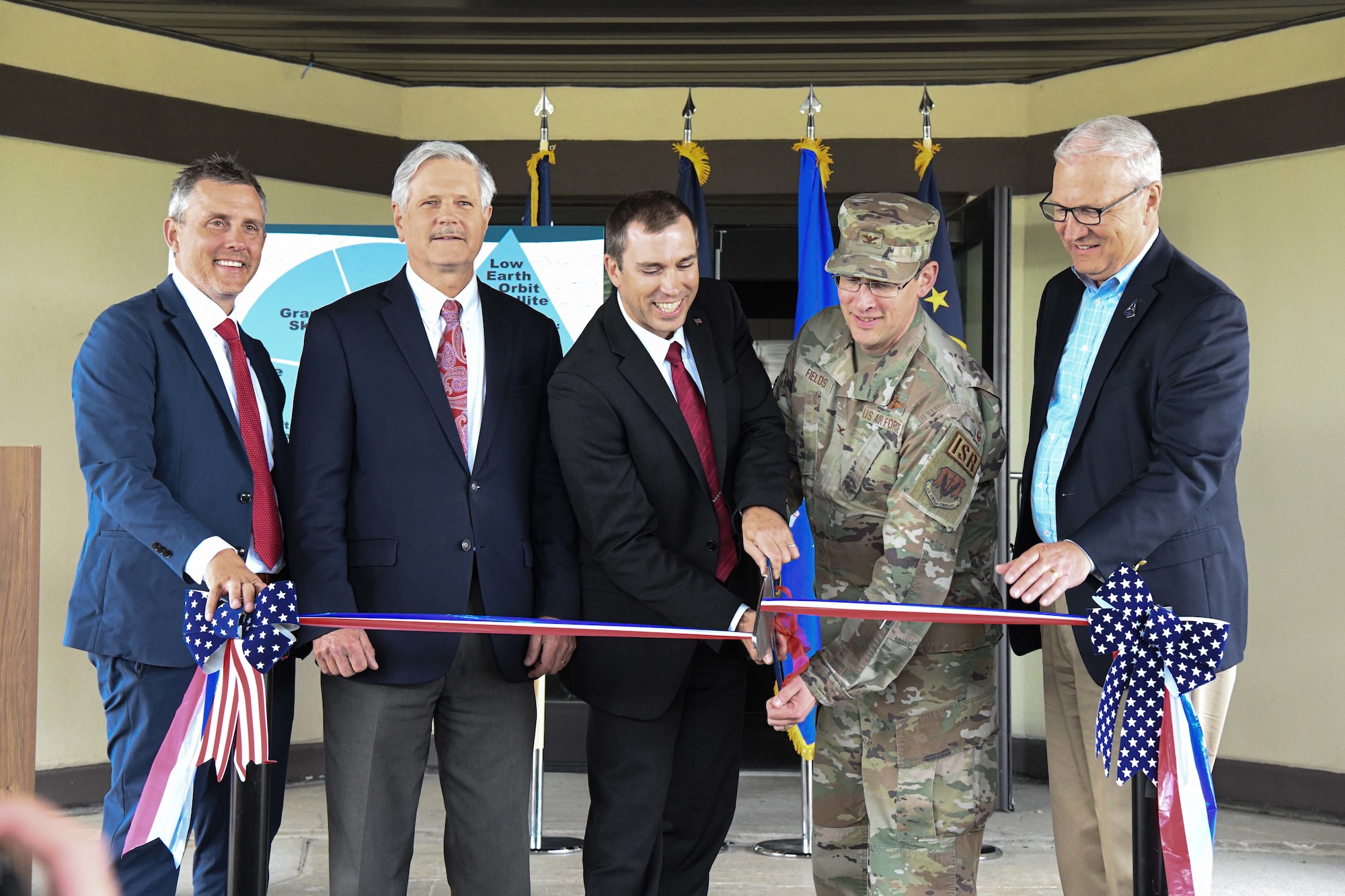 Rep. Kelly Armstrong (R-ND), left, Sen. John Hoeven (R-ND), Derek Tournear, Space Development Agency director, U.S. Air Force Col. Jeremy Fields, 319th Reconnaissance Wing vice commander, and Sen. Kevin Cramer (R-ND),right, cut the ribbon to begin construction and renovations at the new Ground Operations and Integration Center June 28, 2022, at Grand Forks Air Force Base, North Dakota. Grand Forks AFB was selected as one of two ground operation centers that will operate Space Development Agency ground entry points required to uplink and downlink data, and lead ground-to-space integration efforts. Space Development Agency is recognized as the Department of Defense’s constructive disruptor for space acquisition and will accelerate delivery of needed space-based capabilities to the joint warfighter to support terrestrial missions through development, fielding and operation of the National Defense Space Architecture. (U.S. Air Force photo by Senior Airman Ashley Richards)