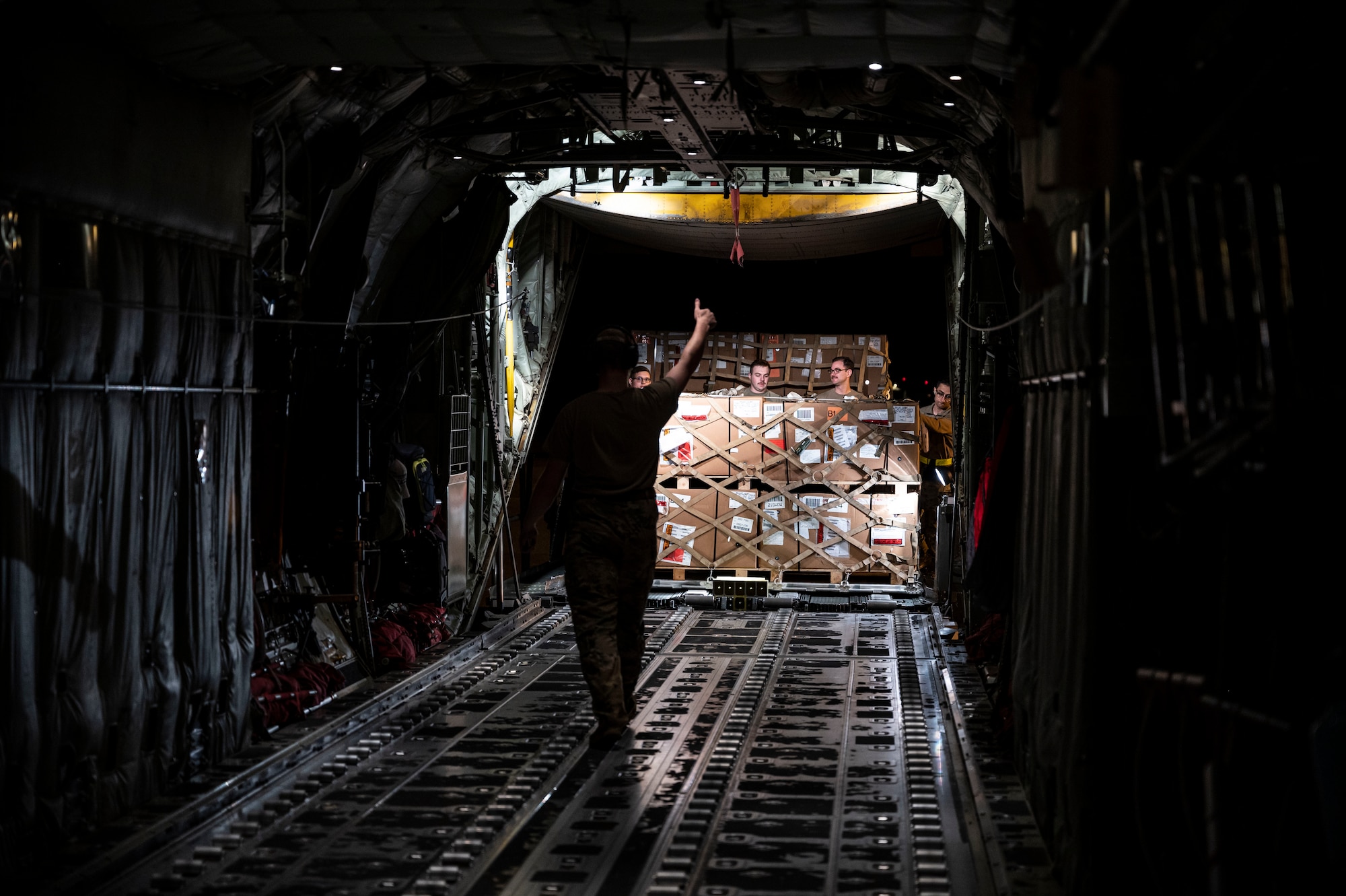 Airmen from the 436th Aerial Port Squadron assist in loading aircraft engine cargo onto a C-130J Super Hercules bound for Africa during a foreign military sales mission at Dover Air Force Base, Delaware, June 24, 2022. The United States and its African partners have a shared interest in a secure, stable, and prosperous African continent. Due to its strategic location, Dover AFB supports approximately $3.5 billion worth of foreign military sales annually. (U.S. Air Force photo by Staff Sgt. Marco A. Gomez)