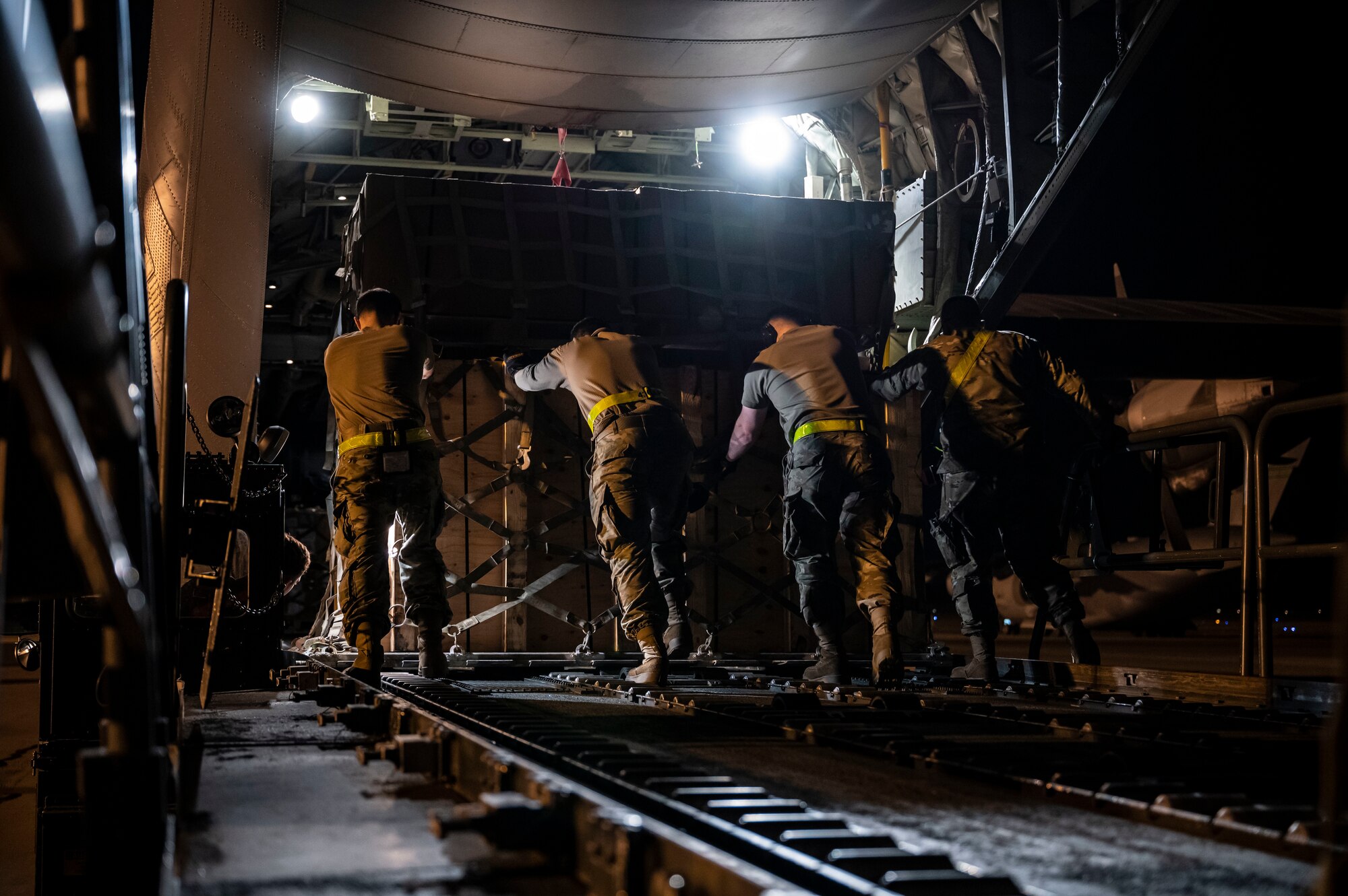 Ramp services personnel from the 436th Aerial Port Squadron, load a pallet onto a C-130J Super Hercules bound for Africa during a foreign military sales mission at Dover Air Force Base, Delaware, June 24, 2022. The United States and its African partners have a shared interest in a secure, stable, and prosperous African continent. Due to its strategic location, Dover AFB supports approximately $3.5 billion worth of foreign military sales annually. (U.S. Air Force photo by Staff Sgt. Marco A. Gomez)