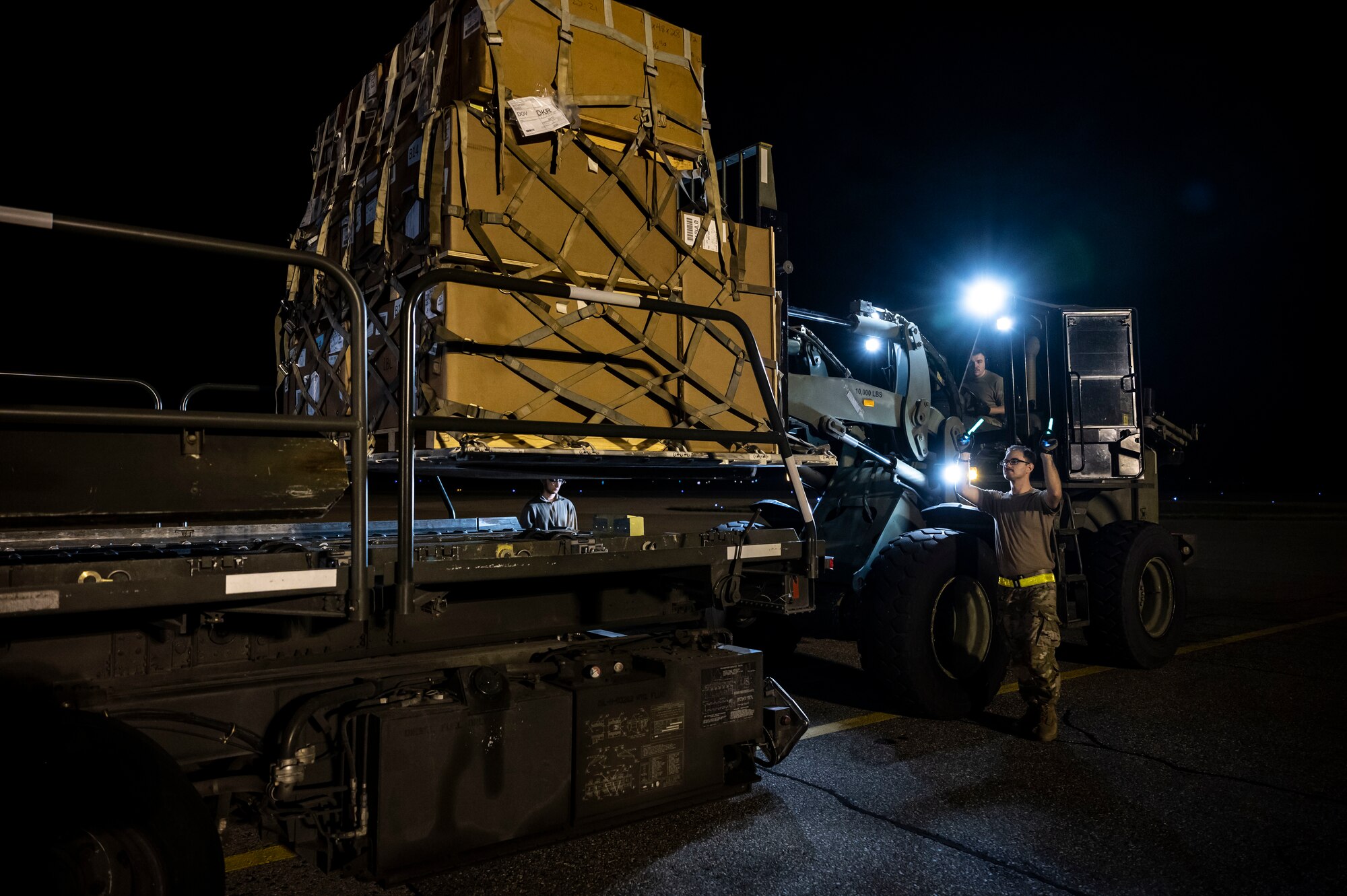 Tech. Sgt. Ryan Cameron, 436th Aerial Port Squadron ramp services supervisor, guides cargo onto a C-130J Super Hercules bound for Africa during a foreign military sales mission at Dover Air Force Base, Delaware, June 24, 2022. The United States and its African partners have a shared interest in a secure, stable, and prosperous African continent. Due to its strategic location, Dover AFB supports approximately $3.5 billion worth of foreign military sales annually. (U.S. Air Force photo by Staff Sgt. Marco A. Gomez)
