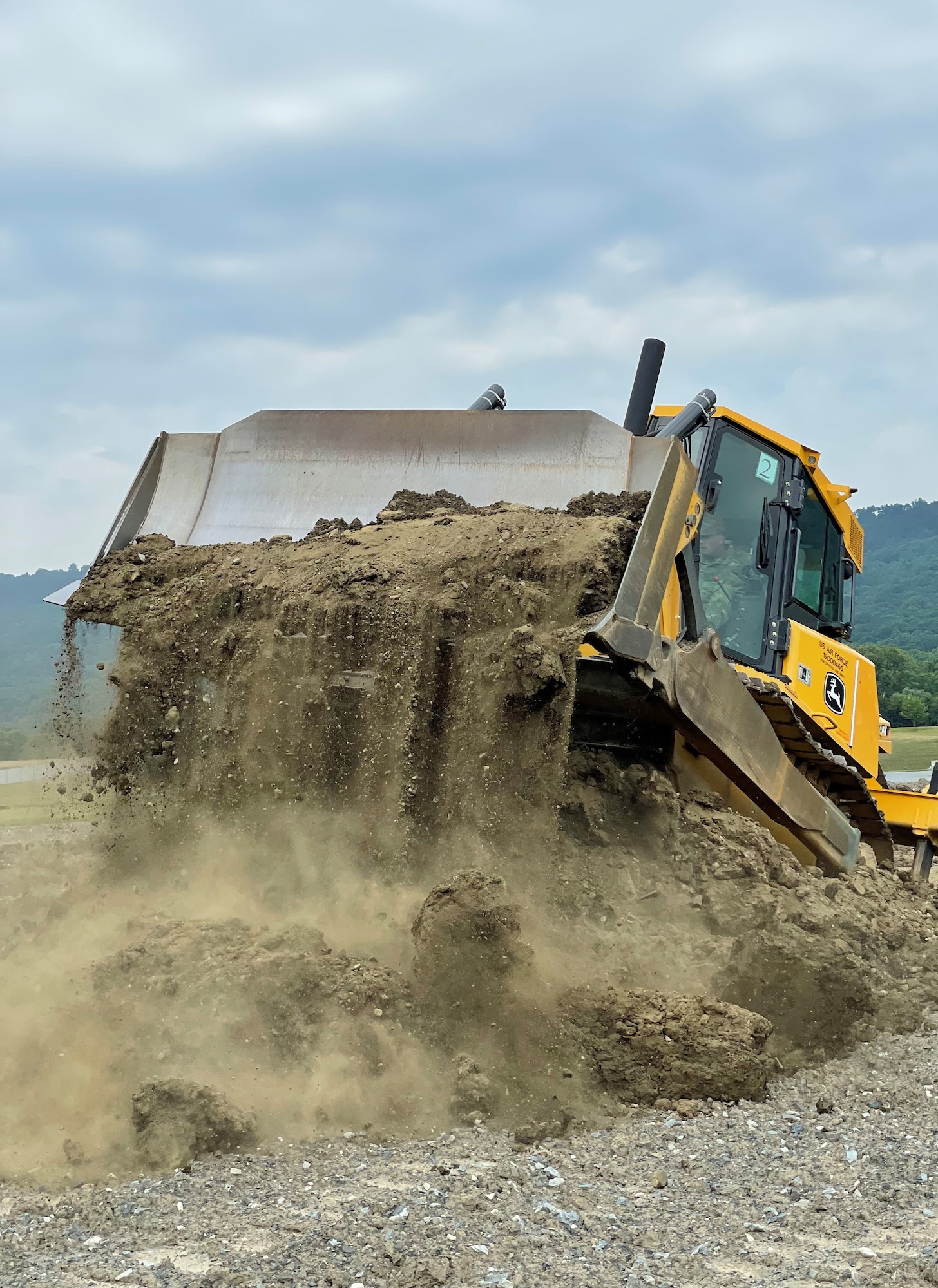 An Airmen assigned to the 175th Civil Engineer Squadron, Maryland Air National Guard, manuevers a piece of heavy equipment at Ft. Indiantown Gap, Pennsylvania, June 22, 2022.