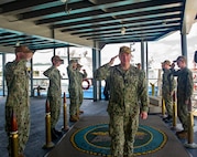 Rear Adm. Rick Seif, Commander, Submarine Group 7, is piped aboard the Emory S. Land-class submarine tender USS Frank Cable (AS 40) during a visit to the ship, June 10, 2022. Frank Cable, forward-deployed to the island of Guam, repairs, rearms, and re-provisions submarines and surface vessels in the Indo-Pacific region. (U.S. Navy photo by Mass Communication Specialist Seaman Wendy Arauz/Released)