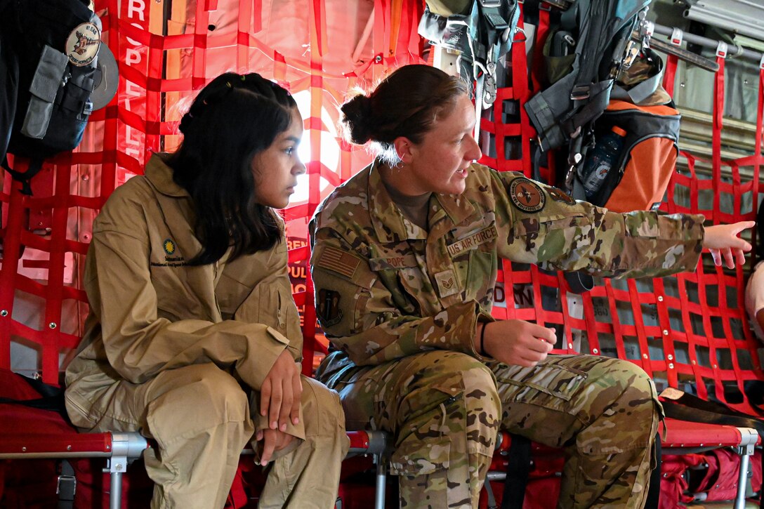 An airman gives a tour of an aircraft to a student.