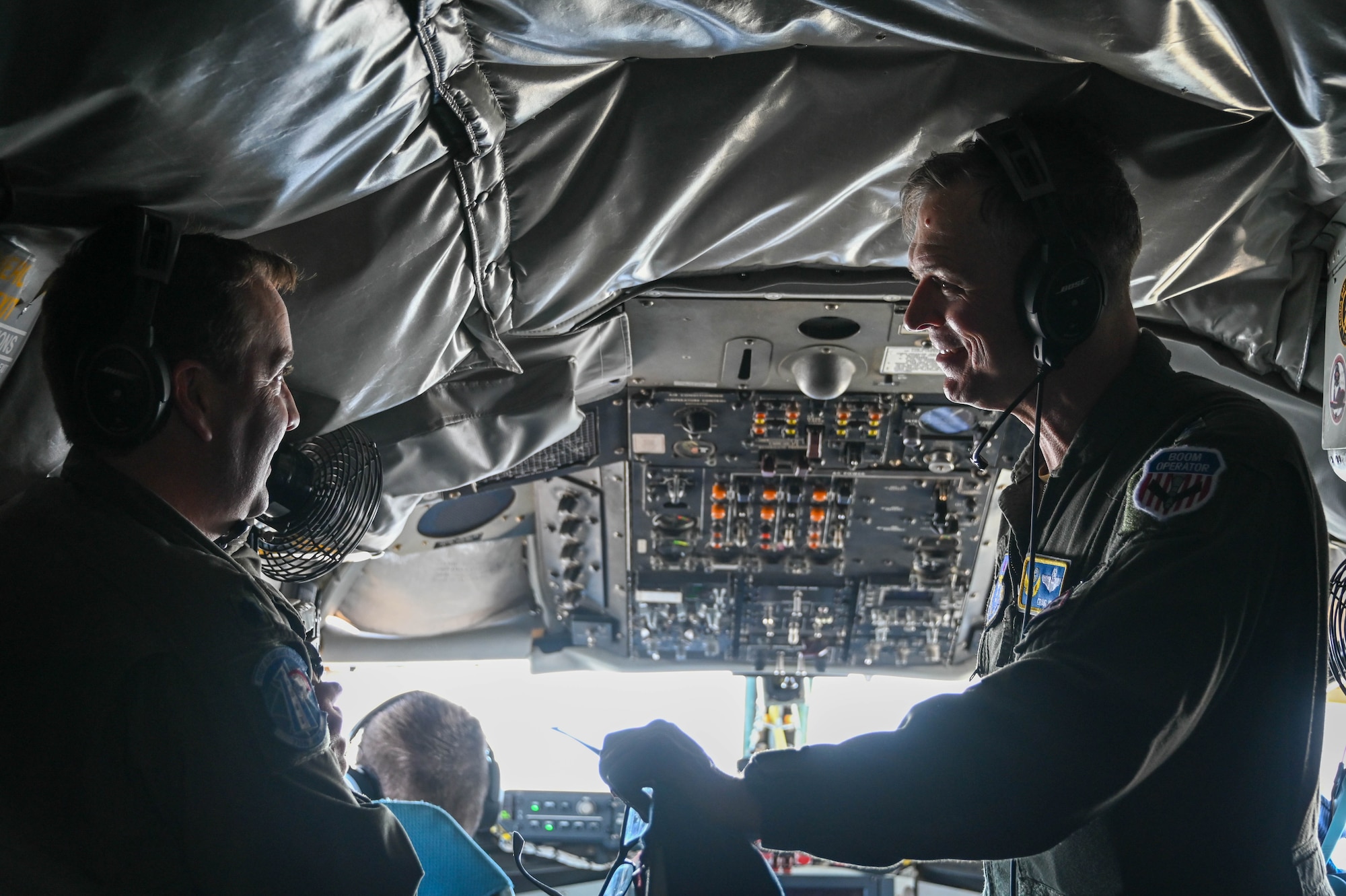 U.S. Air Force Lt. Col. John Hancock (left), 730th Air Mobility Training Squadron, talks with Maj. Gen. Craig D. Wills, 19th Air Force commander, on a KC-135 Stratotanker during a flight, June 23, 2022. Wills talked with student pilots and boom operators about current and future training changes. (U.S. Air Force photo by Senior Airman Kayla Christenson)