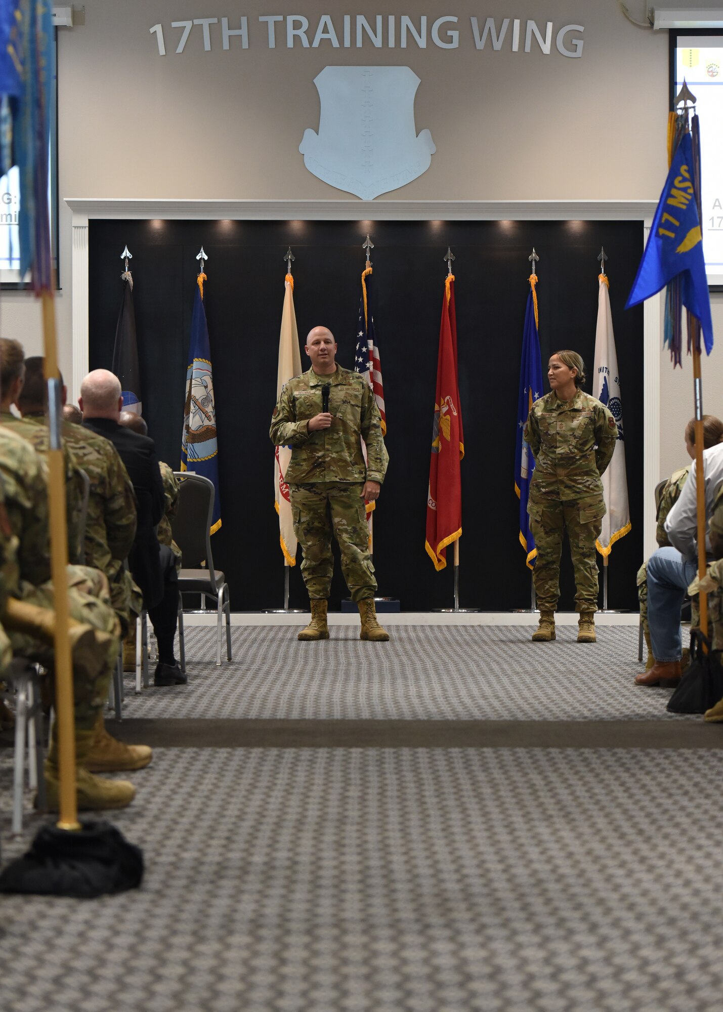 U.S. Air Force Col. Matthew Reilman, 17th Training Wing commander, speaks with Chief Master Sgt. Rebecca Arbona, 17th TRW command chief, during the Commander’s Call at Goodfellow Air Force Base, Texas, June 27, 2022. Reilman identified the importance of developing resiliency in Airmen and their families. (U.S. Air Force photo by Airman 1st Class Zachary Heimbuch)