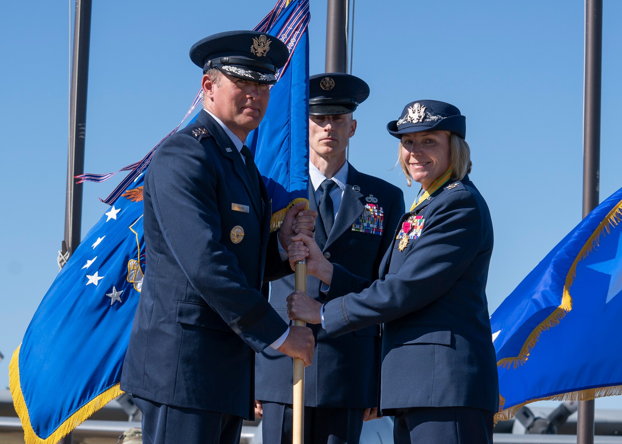 A photo of Lt. Gen. Krumm and Col. Kirsten Aguilar holding a guidon