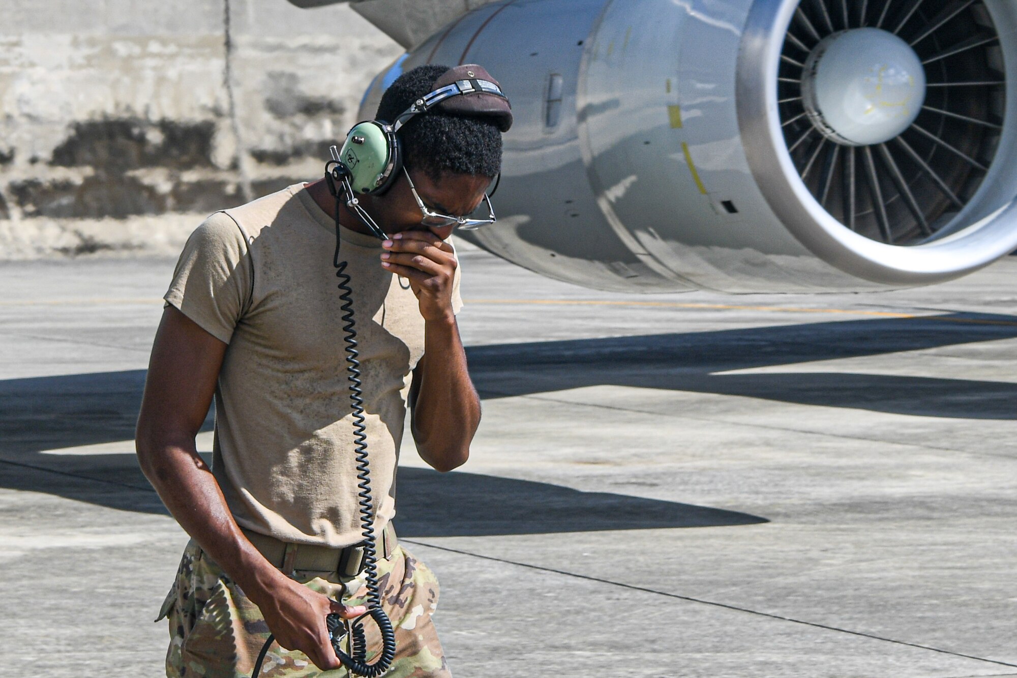 An Airman communicates while testing aircraft engines.