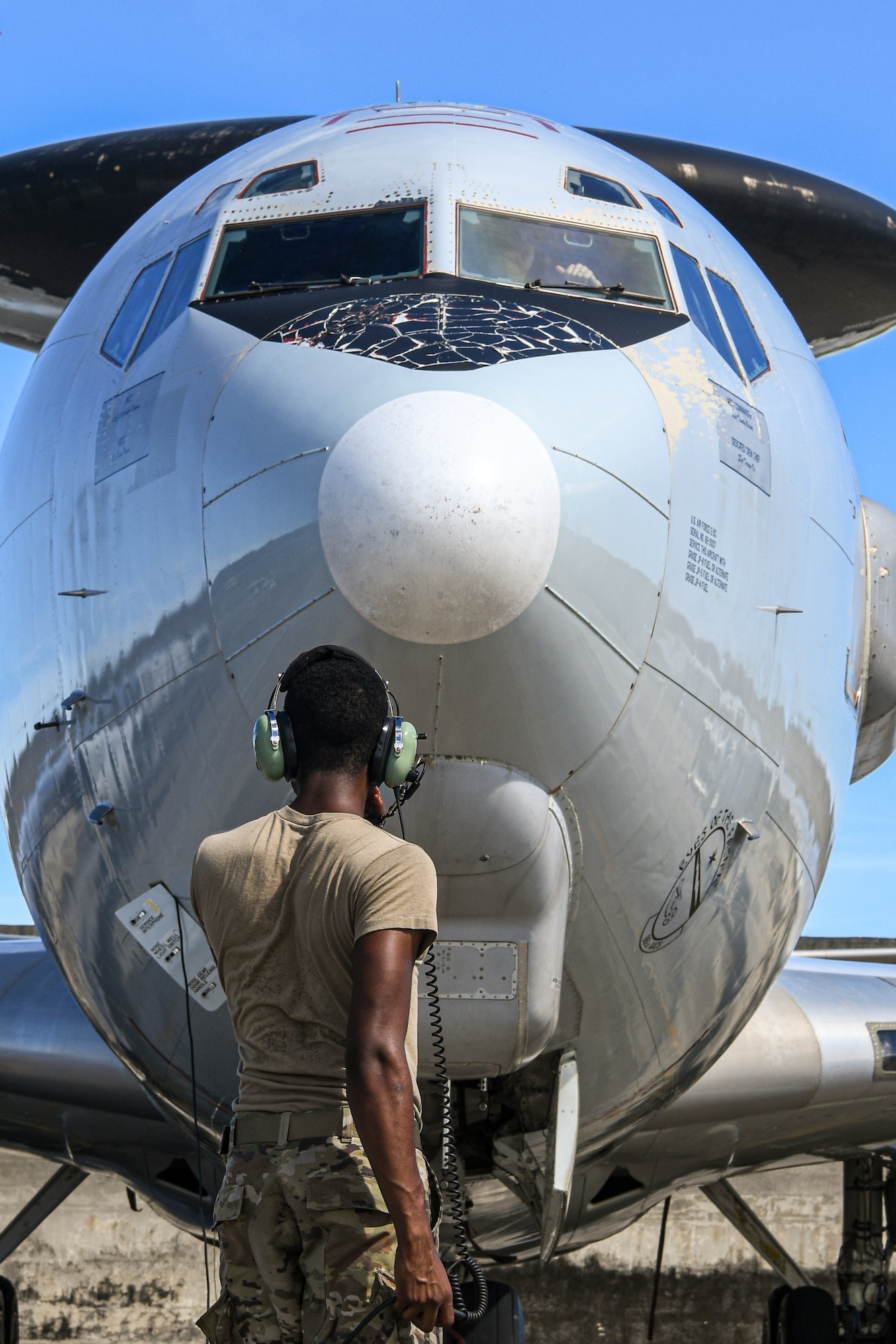 An Airman communicates while testing aircraft engines.