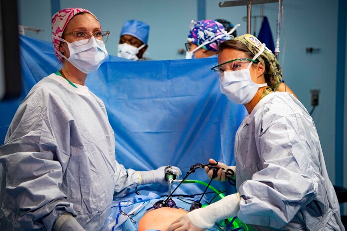 Cmdr. Stephanie Bedzis, right, from Guam, and Lt. Cmdr. Carolyn Gosztyla, perform a laparoscopic surgery aboard Military Sealift Command hospital ship USNS Mercy (T-AH 19) during Pacific Partnership 2022 (PP22).
