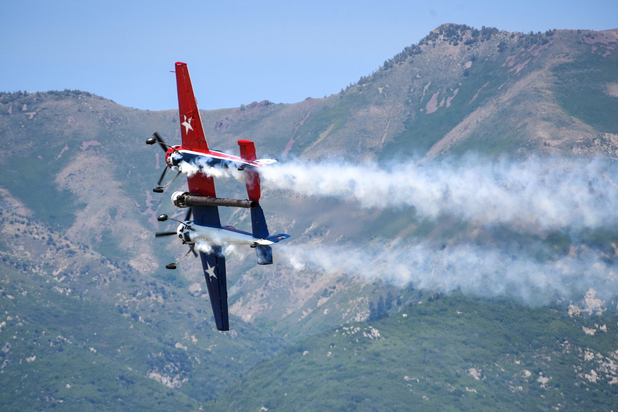 A Yak-110 aircraft flying with smoke spewing behind.