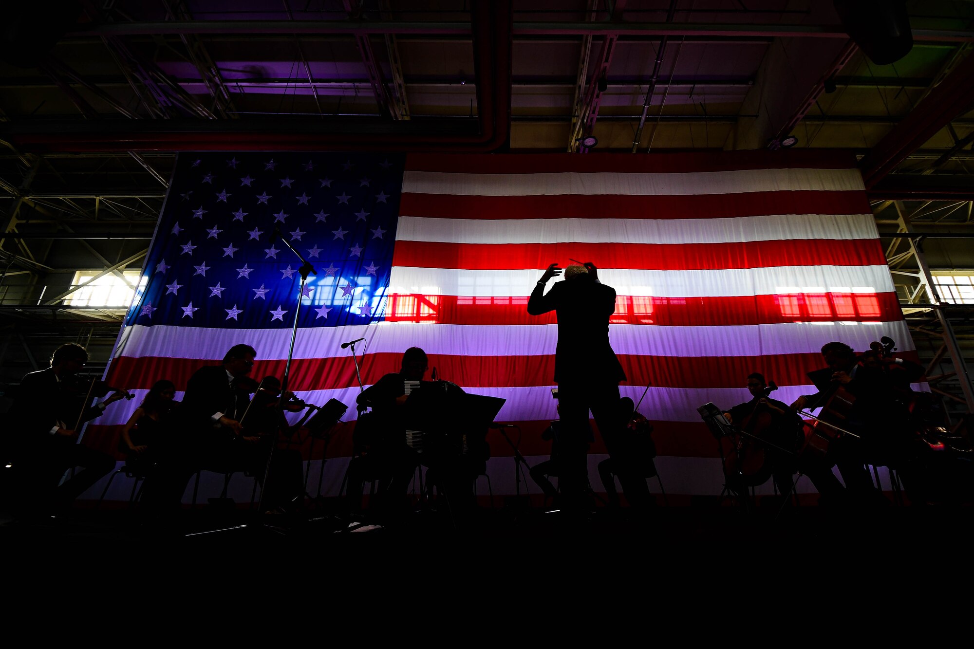 U.S. Air Force Brig. Gen. Jason Bailey, 31st Fighter Wing Commander, speaks at the Chamber Orchestra “Nuova Orchestra da Camera Ferruccio Busoni” concert at Aviano Air Base, Italy, June 29, 2022. They were directed by Maestro Massimo Belli and performed “Melodies of the Century”. The goal of these events is to bring two nations together through music, international language and a sense of community. (U.S. Air Force photo by Senior Airman Noah Sudolcan)