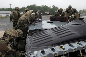 193rd Special Operations Aircraft Maintenance Squadron Airmen from Middletown, Pennsylvania Air National Guard, assess battle damage to a wing of a C-130 during a training exercise held at Fort Indiantown Gap, Annville, Pennsylvania June 23, 2022.