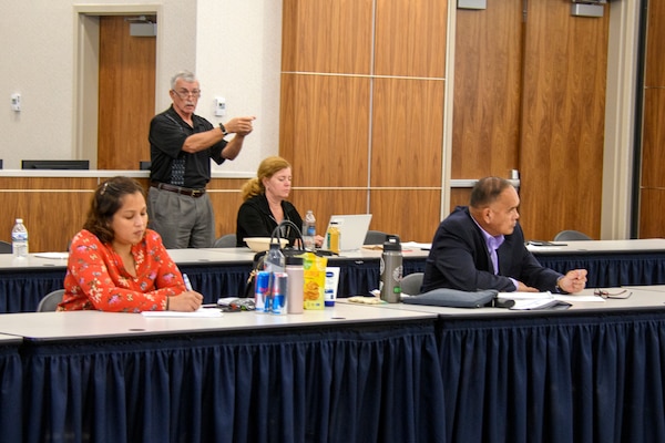 D. Michael Hinkley, senior investigor for Commander, Navy Installations Command (CNIC) Inspector General's Office, speaks at the annual CNIC Office of the Inspector General Symposium.