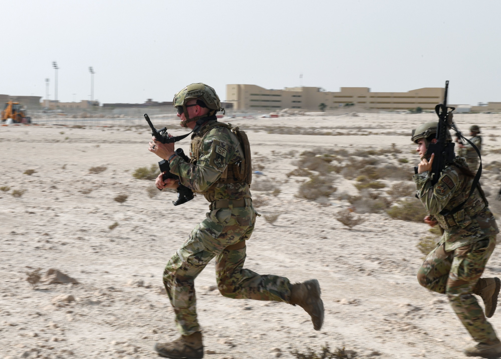 379th Security Forces Squadron defenders dash into position during pre-deployment training April 21, 2022, at Al Udeid Air Base, Qatar. The Defenders put into action Agile Combat Employment (ACE) skills to the test during Accurate Test 22 in Oman. (U.S. Air National Guard photo by Airman 1st Class Constantine Bambakidis)